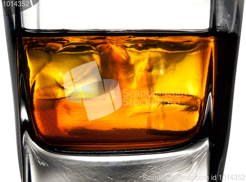 Image of Glass of whiskey with ice cubes