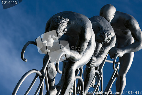Image of Three cyclists rides  in a downhill