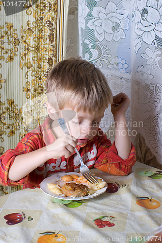 Image of The boy has dinner