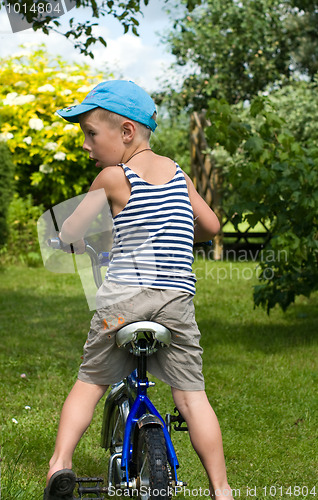 Image of The boy with a bicycle