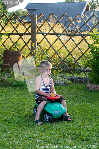 Image of The boy is taken for a ride in a car.