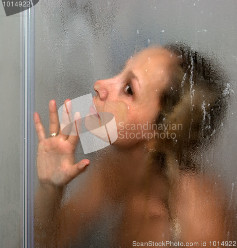 Image of A girl is in a shower cubicle.