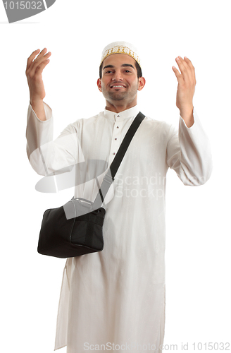 Image of Ethnic man with arms raised in praise