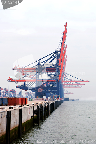 Image of Idle harbor cranes on a misty morning