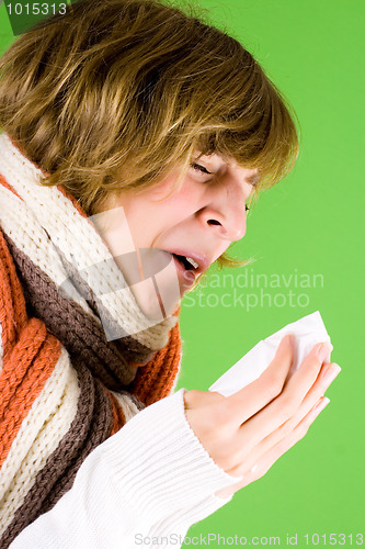 Image of portrait of a cold girl sneezes 