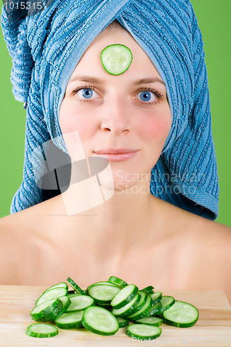 Image of woman in blue towel and mask from cucumber