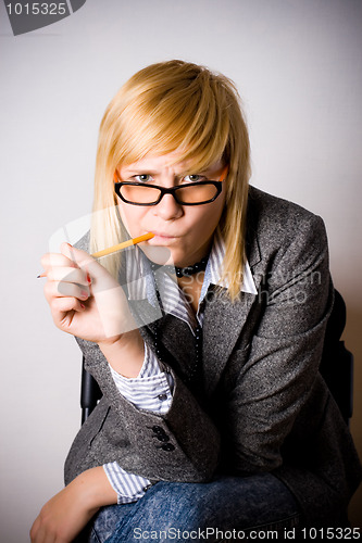 Image of young businesswoman with pencil 