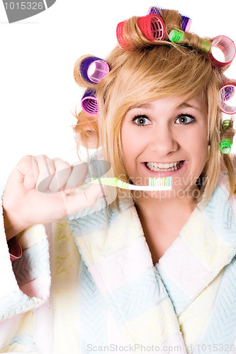 Image of funny housewife with curlers and toothbrush