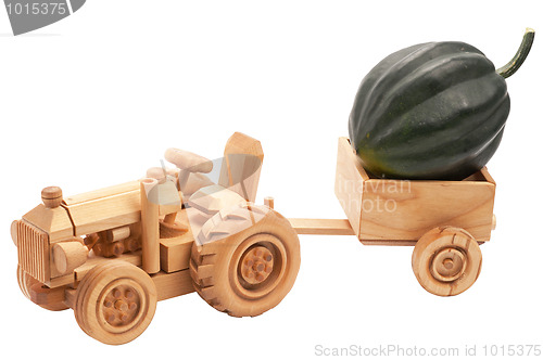 Image of Toy tractor with green pumpkin.