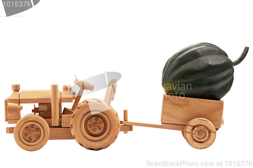 Image of Toy tractor with green pumpkin.