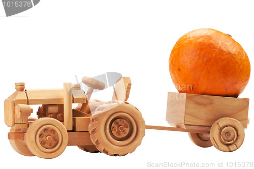 Image of Toy tractor with orange pumpkin.