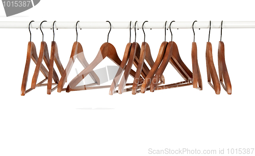 Image of Many wooden hangers on a rod