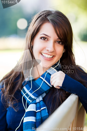 Image of Mixed race college student listening to music