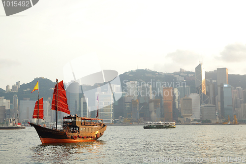 Image of Hong Kong harbor with red sail boat