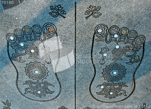Image of Buddha's soles with some coins(Japanese yens)from the belivers