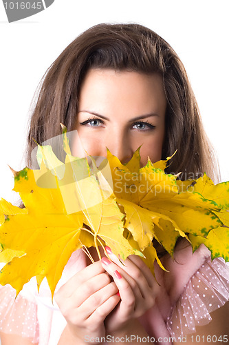 Image of young woman with yellow leaves