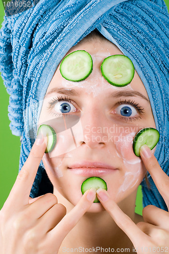 Image of woman in blue towel and mask from cucumber
