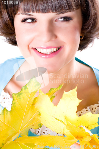 Image of young woman with yellow leaves