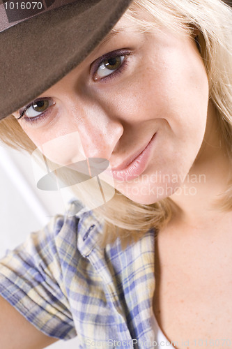 Image of pretty western woman in cowboy shirt and hat