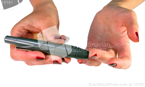 Image of  Hands using a device for blood sampling for blood glucose self-monitoring,corect position,educational image for diabetic patients.