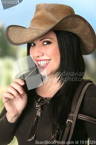 Image of Smiling Cowgirl chewing on lucerne