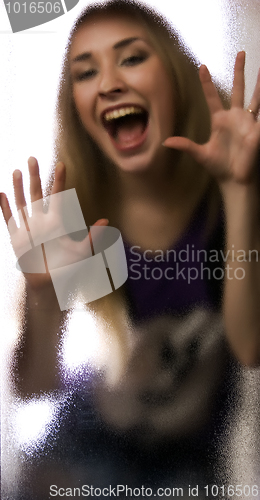 Image of Girl behind the glass  door 