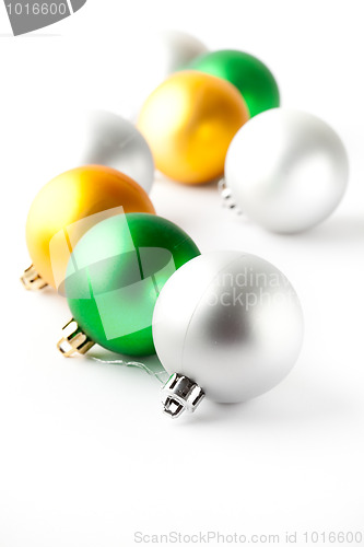 Image of Green, gold and silver Christmas baubles on white