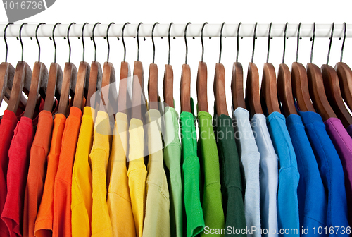 Image of Rainbow colors, clothes on wooden hangers