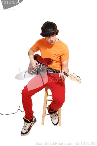Image of Teen boy with guitar.