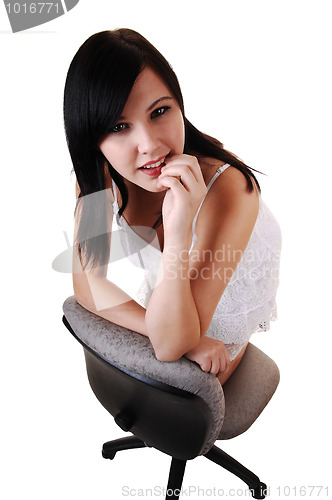 Image of Girl kneeling on chair.