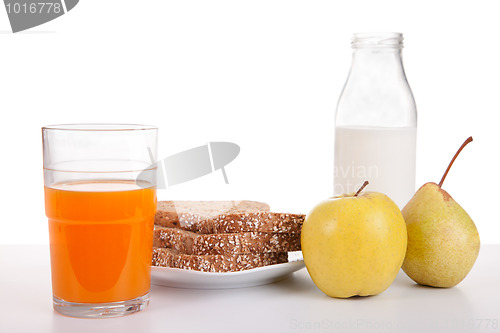 Image of Breakfast: juice, fruit (apple and pear), bread, cereal and milk