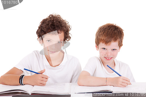 Image of Two students with a pencil, writing