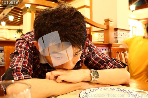 Image of Portrait of a asia man bend on the table