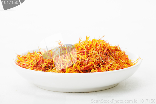 Image of Saffron leaves spice in white dish