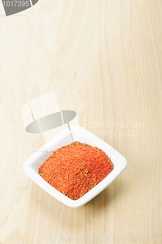 Image of Red spice mixture on wood