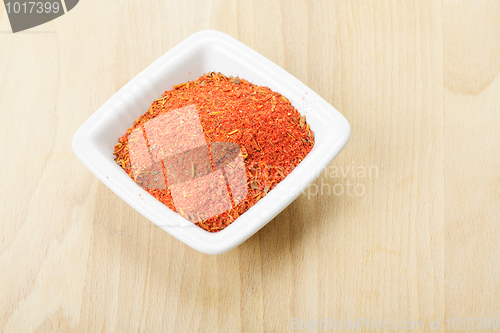 Image of Red spice mixture for fish courses on wood