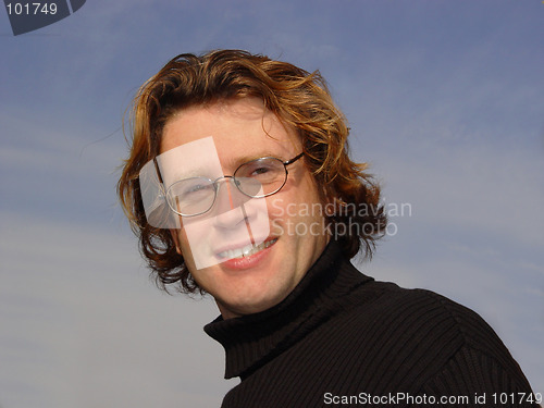 Image of Young man against the blue sky