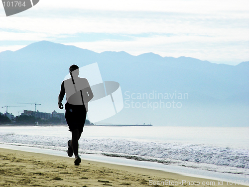 Image of Man running on the beach