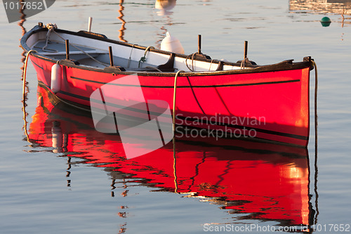 Image of Morning light on a red boat 