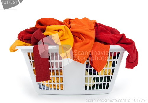 Image of Colorful clothes in laundry basket. Red, orange, yellow.