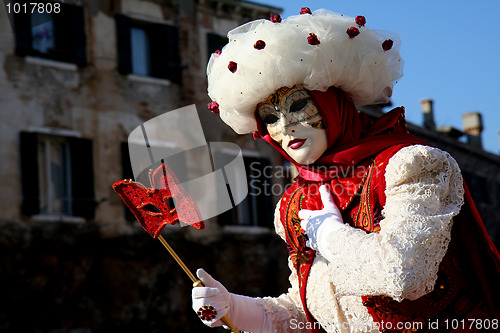 Image of A masked woman with a red eye mask