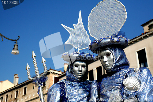 Image of A masked couple,dressd in blue