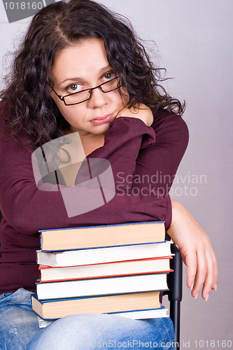 Image of woman with stack of books