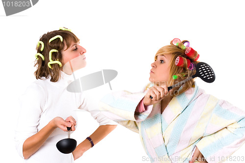 Image of two funny housewifes with  kitchen utensil 