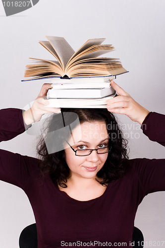 Image of attractive woman with stack of books