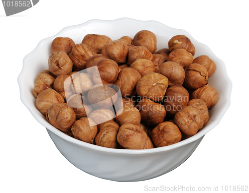 Image of Hazelnuts on a white plate, isolated.