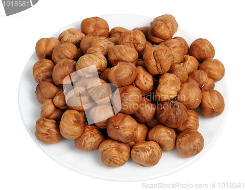 Image of Hazelnuts on a white plate, isolated.