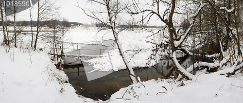 Image of Winter landscape with stream and bridge, panorama from 5 images