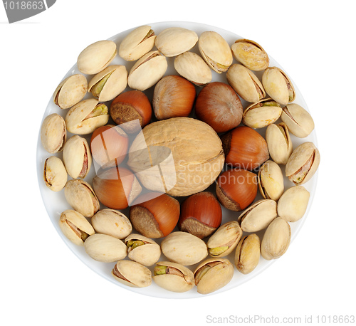 Image of Set of nuts on a white plate, isolation