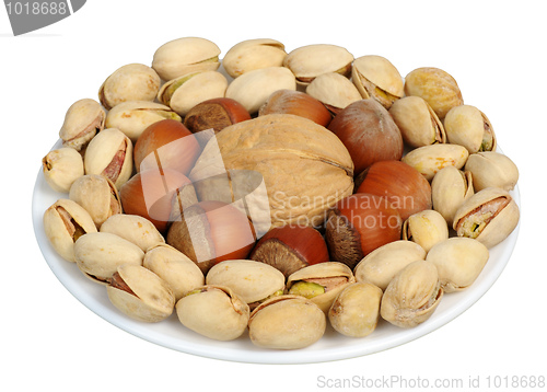 Image of Set of nuts on a white plate, isolation